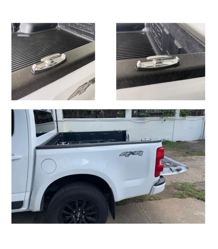 Gancho de amarre metálico de color cromado instalado en el riel de una cama de camioneta.