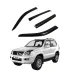 Set de 4 viseras de ventana ahumadas instaladas en una Toyota Prado 2003-2009, mostrando los deflectores de lluvia.